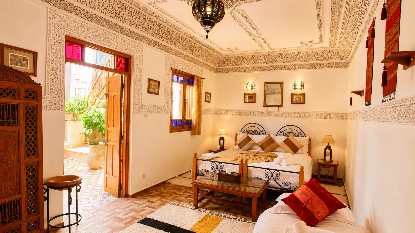 The room opening onto the gallery, with carved friezes and red shutters