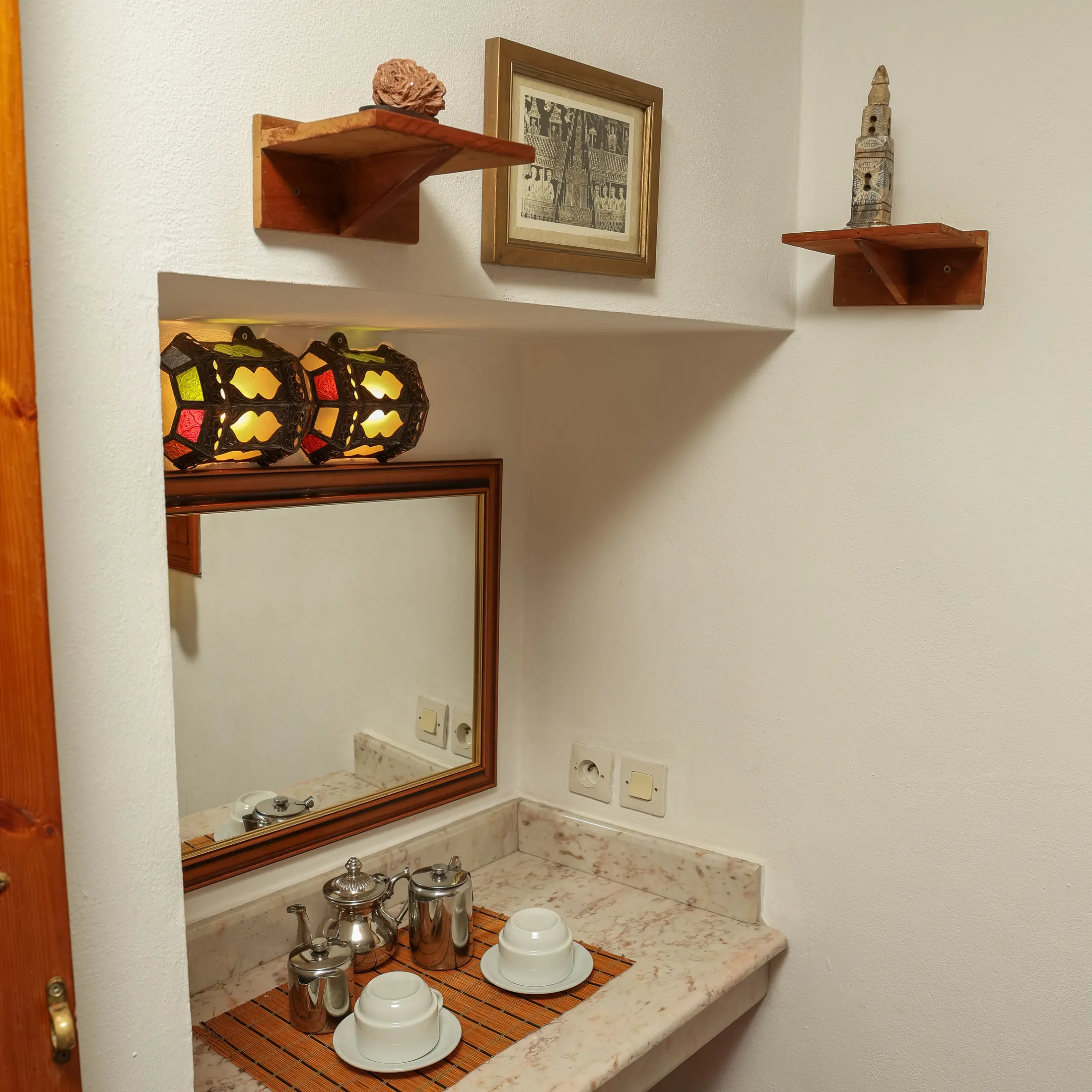 Tea tray and carved mirror on the shelf